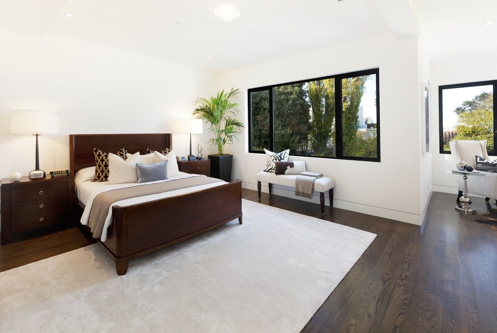 Example of a large trendy master dark wood floor and brown floor bedroom design in San Francisco with white walls and no fireplace