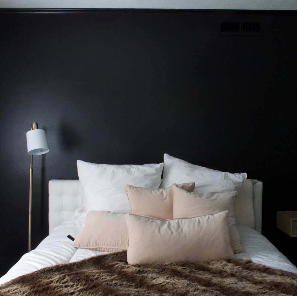 Example of a mid-sized trendy guest dark wood floor and brown floor bedroom design in Cleveland with black walls