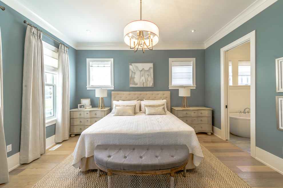 Classic master bedroom in Toronto with blue walls, light hardwood flooring and no fireplace.