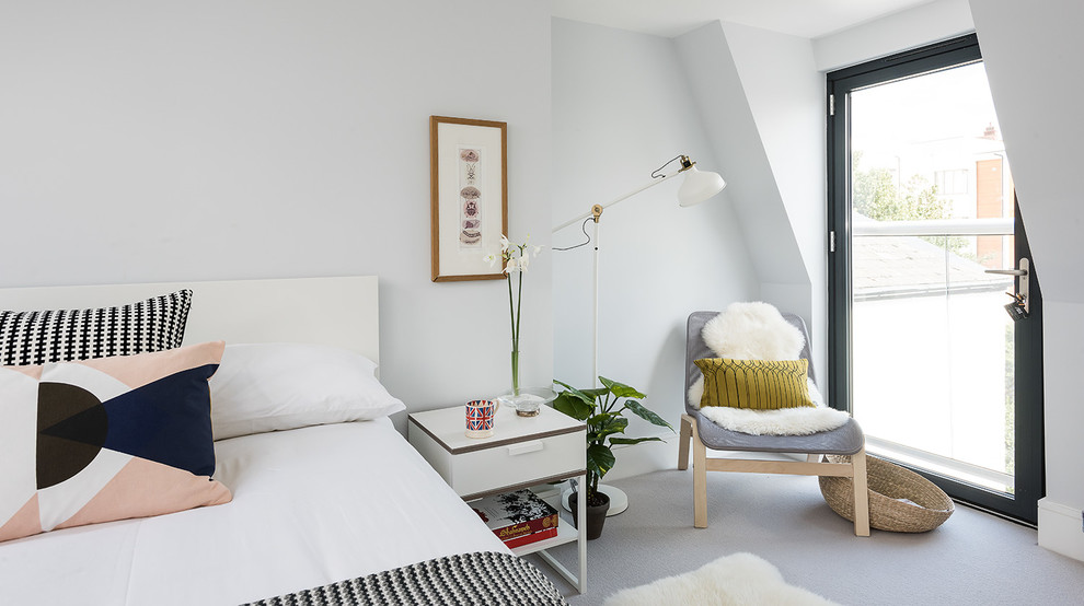 Bild på ett skandinaviskt sovrum, med vita väggar och heltäckningsmatta