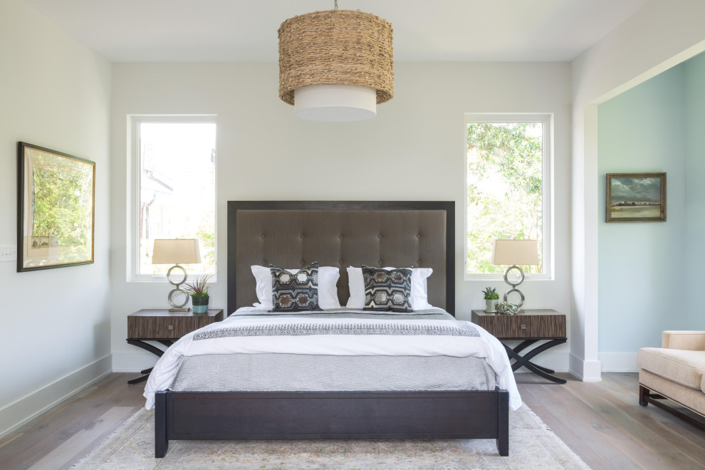 Inspiration for a classic bedroom in New Orleans with white walls, medium hardwood flooring and brown floors.