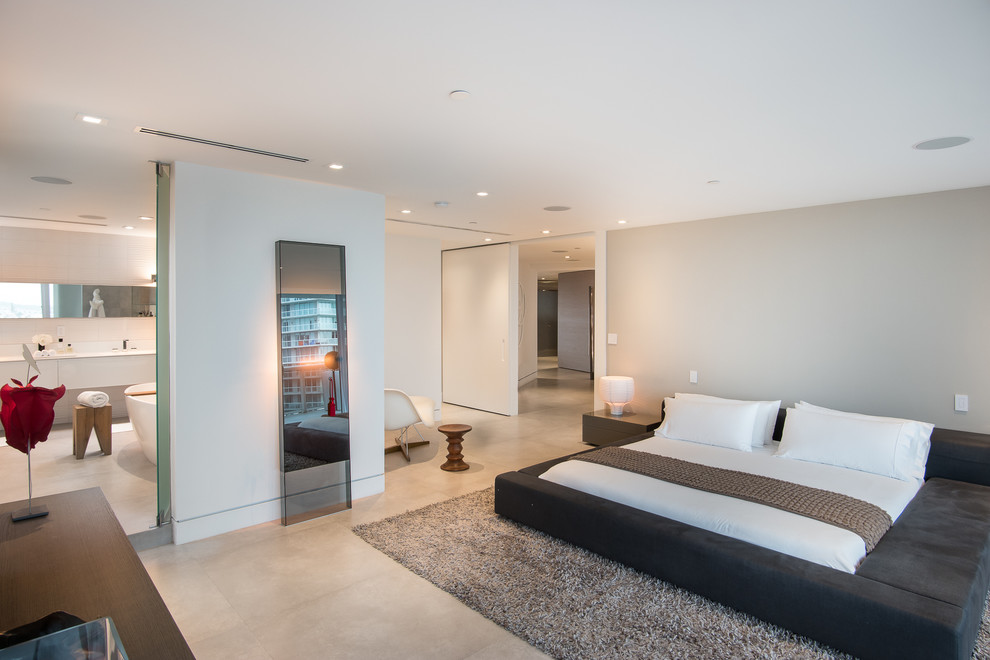 This is an example of a contemporary master bedroom in Miami with grey walls.