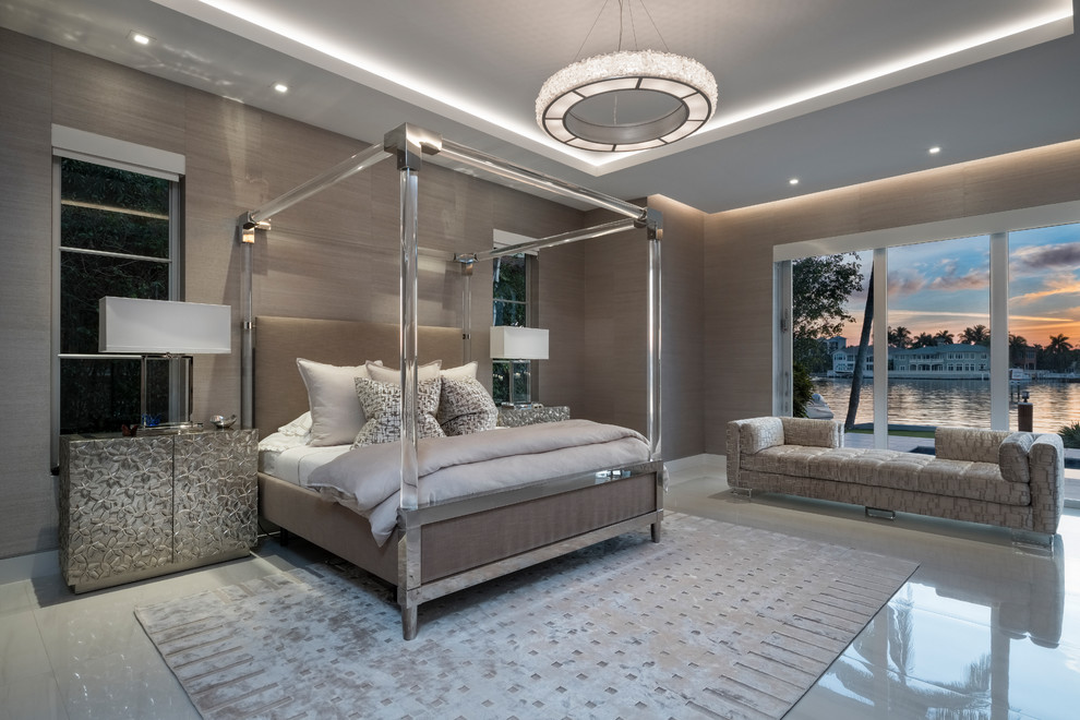 Contemporary master bedroom in Miami with beige walls.