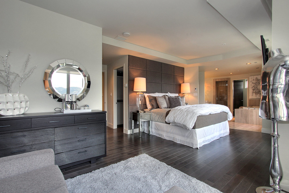 Inspiration for an expansive contemporary master and grey and silver bedroom in Vancouver with white walls, dark hardwood flooring and brown floors.