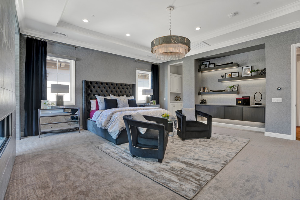 This is an example of a contemporary master and grey and silver bedroom in Orange County with grey walls, carpet, a two-sided fireplace and a tiled fireplace surround.