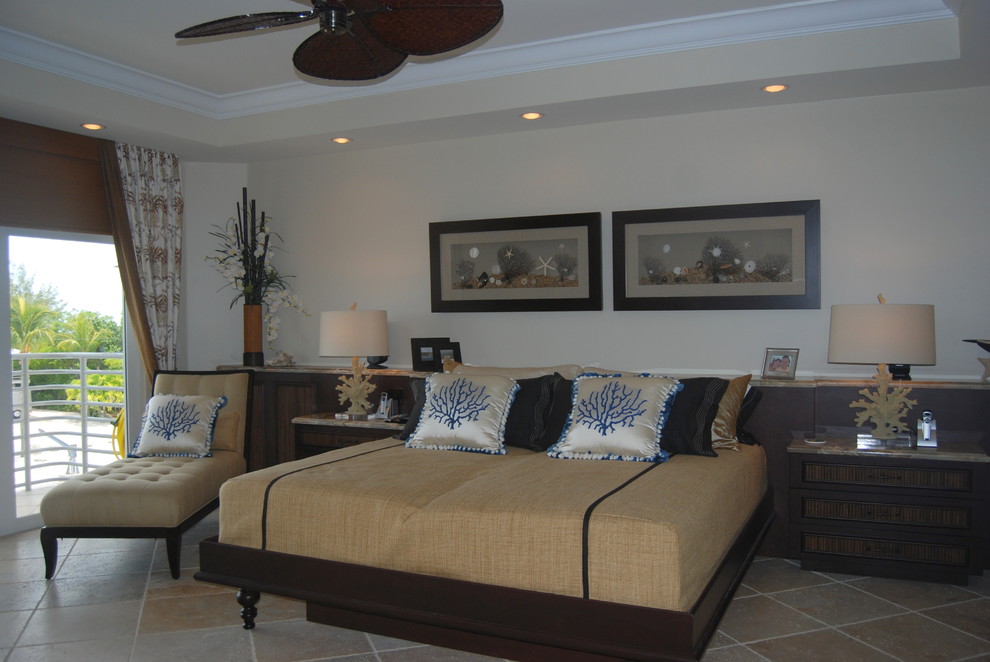 Bedroom - large tropical master travertine floor bedroom idea in Miami