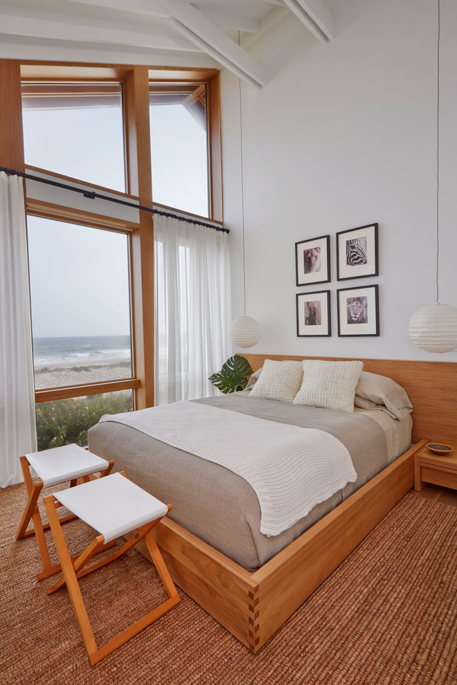 Photo of a medium sized nautical guest bedroom in New York with white walls, medium hardwood flooring, no fireplace and brown floors.