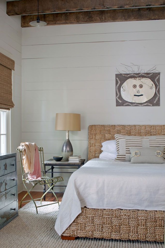 Design ideas for a coastal bedroom in Atlanta with white walls and medium hardwood flooring.