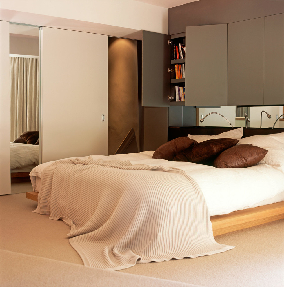 Inspiration for a medium sized contemporary master and grey and brown bedroom in London with white walls, carpet and no fireplace.