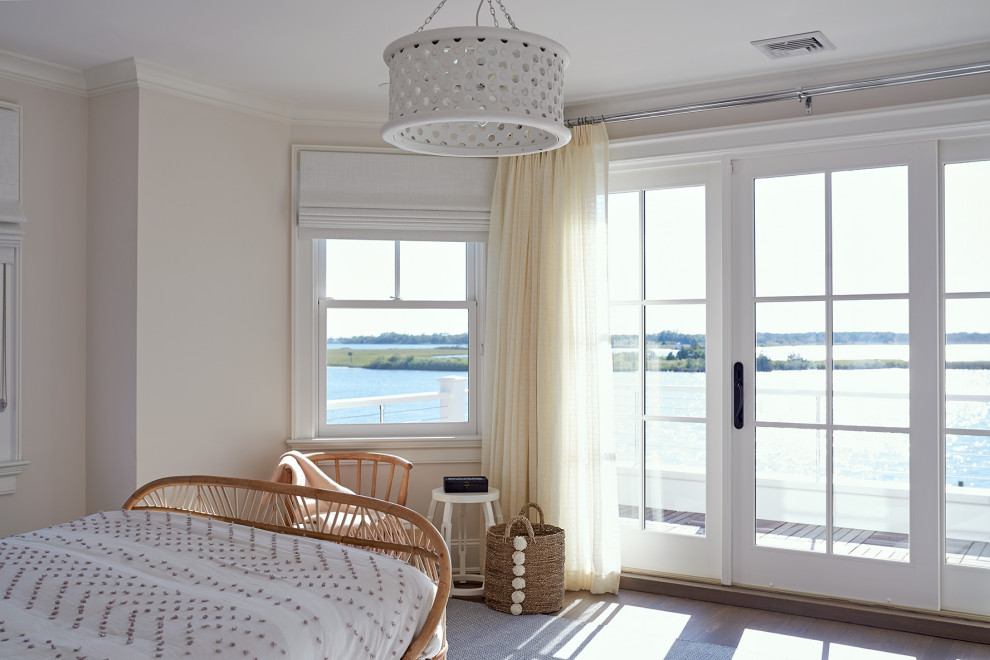 Medium sized coastal guest bedroom in New York with beige walls, medium hardwood flooring, no fireplace and brown floors.