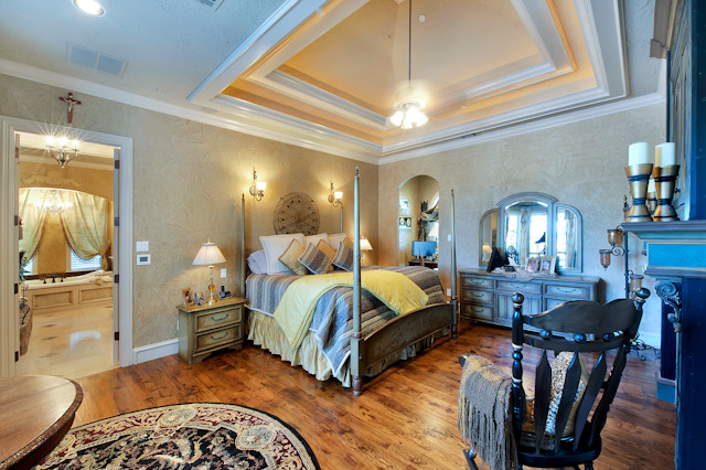 This is an example of an expansive mediterranean master bedroom in Dallas.