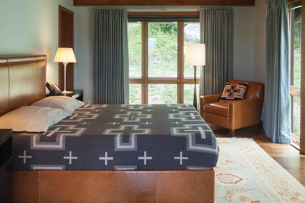 Mountain style medium tone wood floor bedroom photo in Portland with gray walls