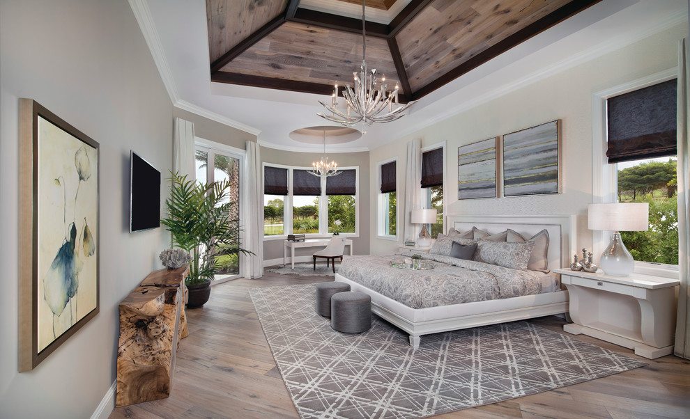 Beach style master bedroom in Miami with light hardwood flooring.