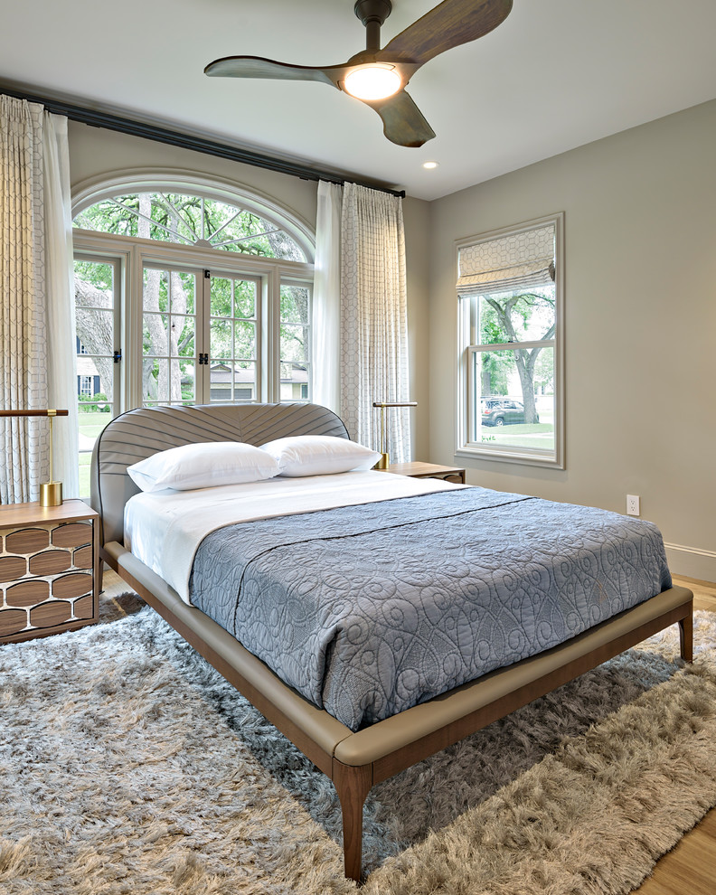Traditional guest bedroom in Austin with beige walls, light hardwood flooring and beige floors.