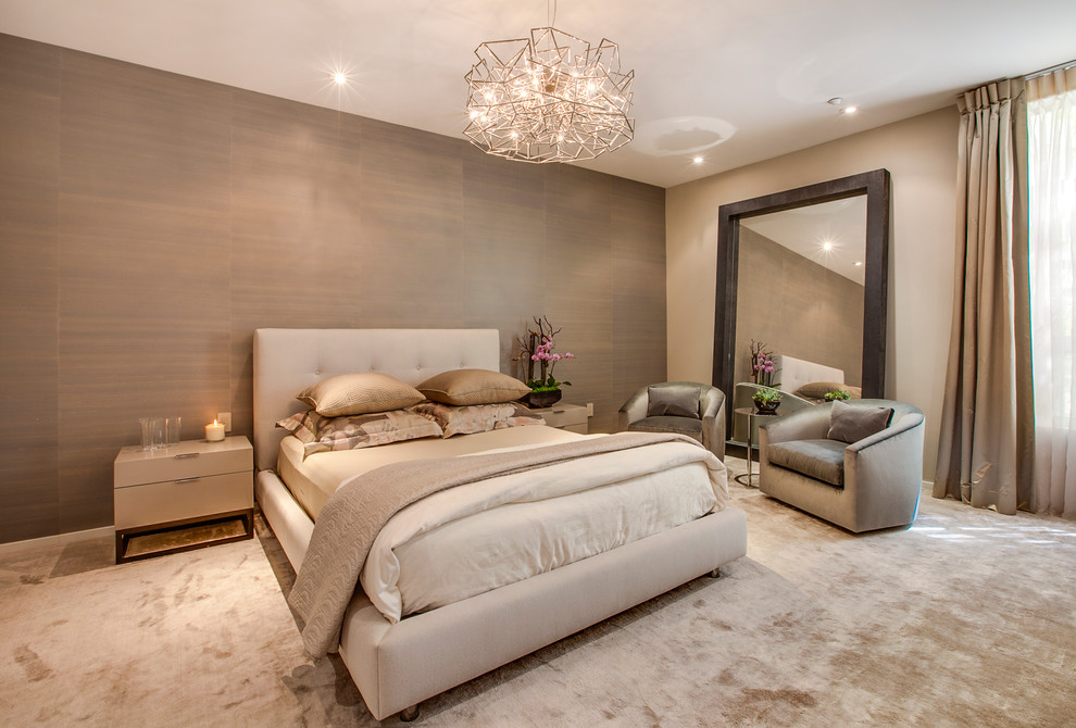 This is an example of a contemporary master bedroom in Los Angeles with brown walls and carpet.
