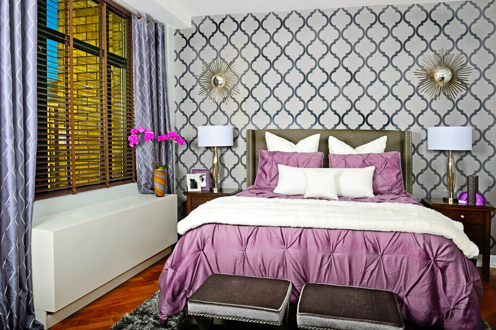 This is an example of a contemporary bedroom in New York with grey walls and medium hardwood flooring.