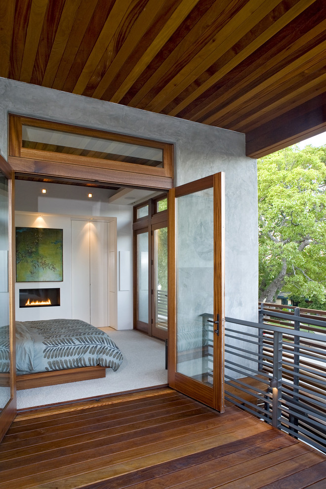 Imagen de dormitorio minimalista con chimenea lineal