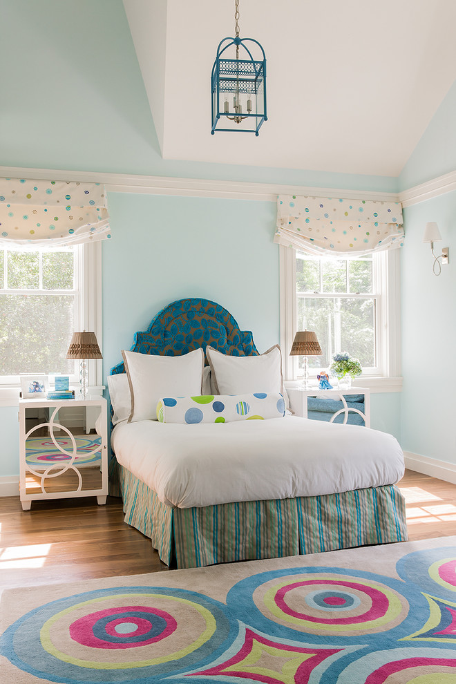 Contemporary bedroom in Miami with blue walls and light hardwood flooring.