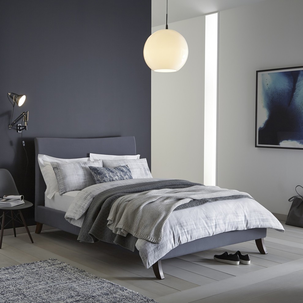 This is an example of a scandinavian grey and white bedroom in London.