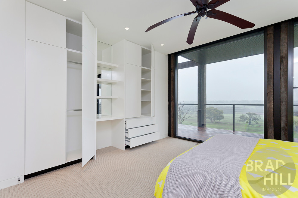 Example of a mid-sized transitional guest carpeted bedroom design in Melbourne with white walls
