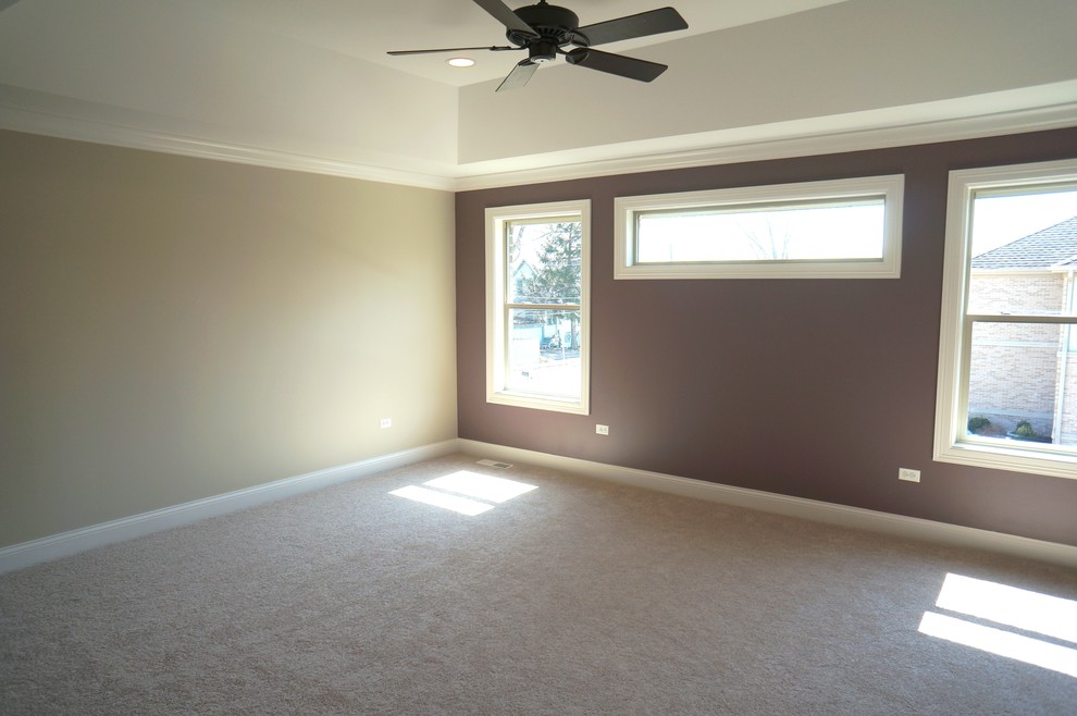 Large elegant master carpeted bedroom photo in Chicago with beige walls