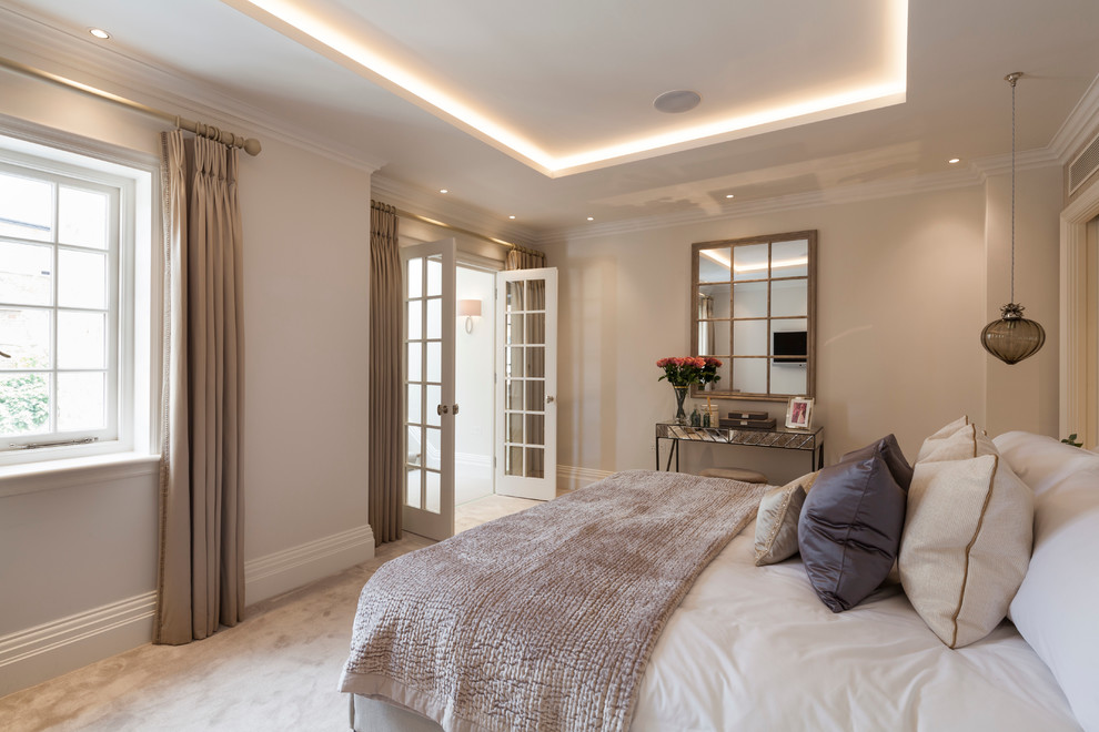Photo of a contemporary bedroom in London with beige walls, carpet and no fireplace.