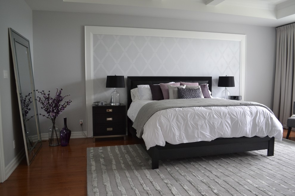 Design ideas for an expansive contemporary master and grey and silver bedroom in Toronto with grey walls and light hardwood flooring.