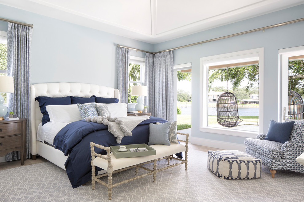 Inspiration for a beach style master bedroom in Miami with blue walls.