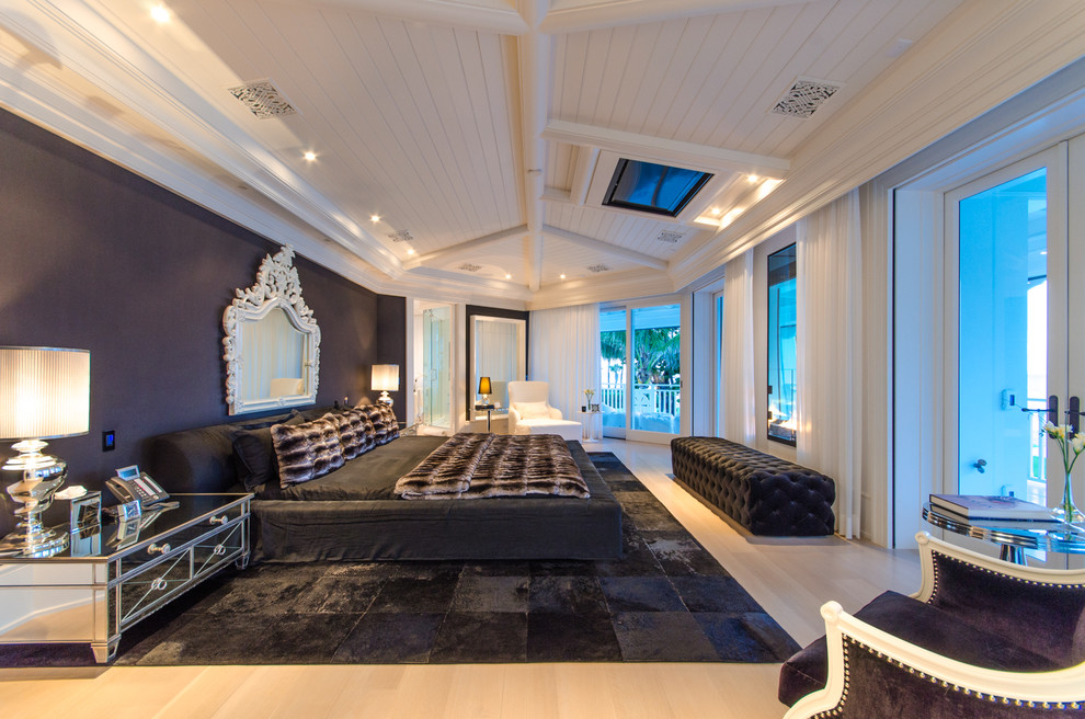 Design ideas for an expansive contemporary master bedroom in Miami with black walls, light hardwood flooring, a two-sided fireplace, beige floors and a timber clad ceiling.