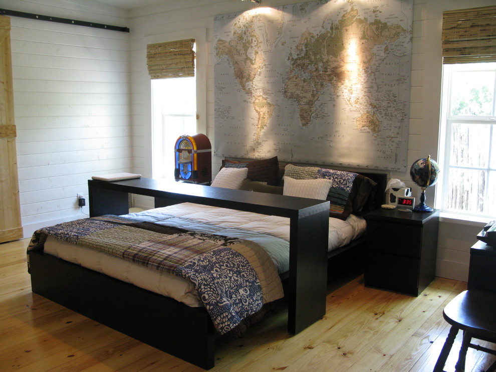 Elegant light wood floor bedroom photo in Austin with white walls