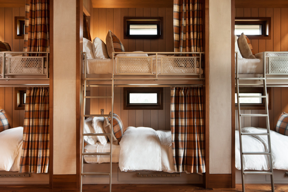 Example of a huge trendy guest dark wood floor and brown floor bedroom design in Denver with beige walls and no fireplace