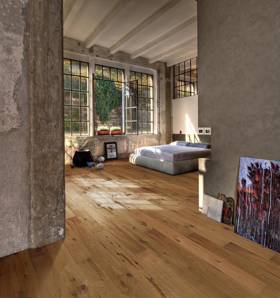 Example of a mid-sized transitional loft-style medium tone wood floor and brown floor bedroom design in New York with brown walls