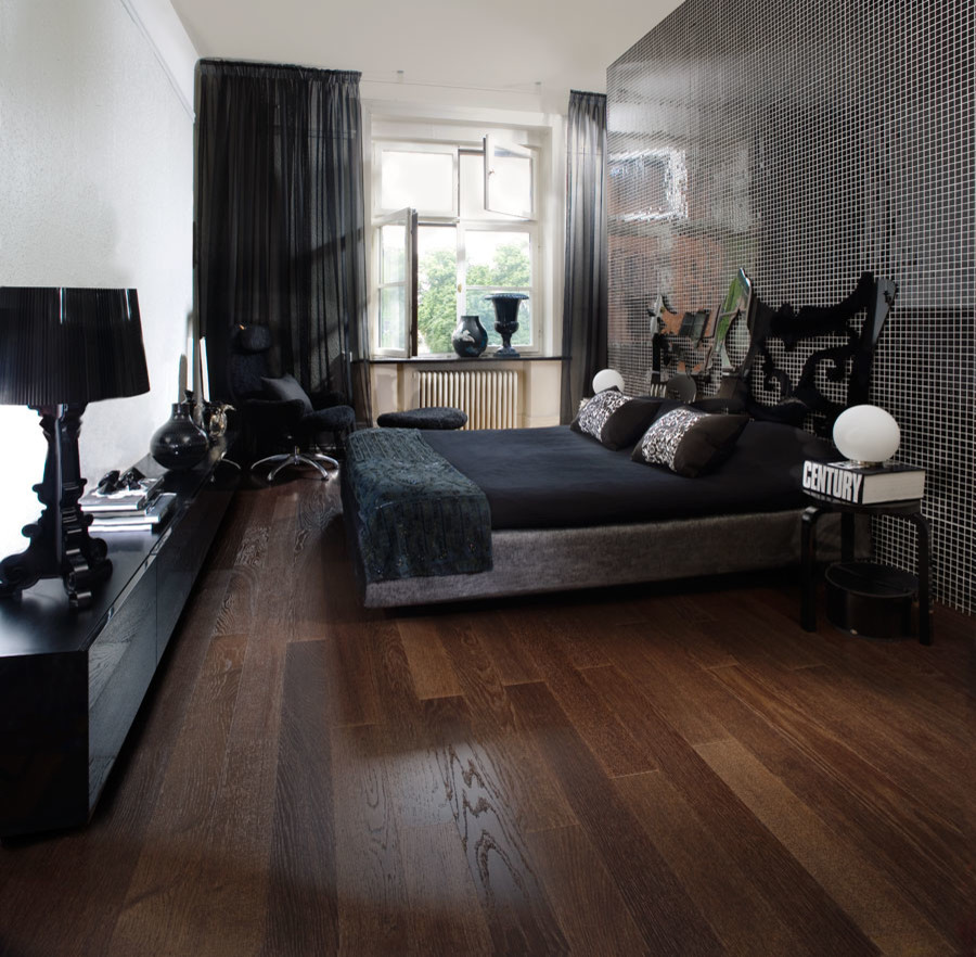 Photo of a small traditional master bedroom in Chicago with black walls and medium hardwood flooring.