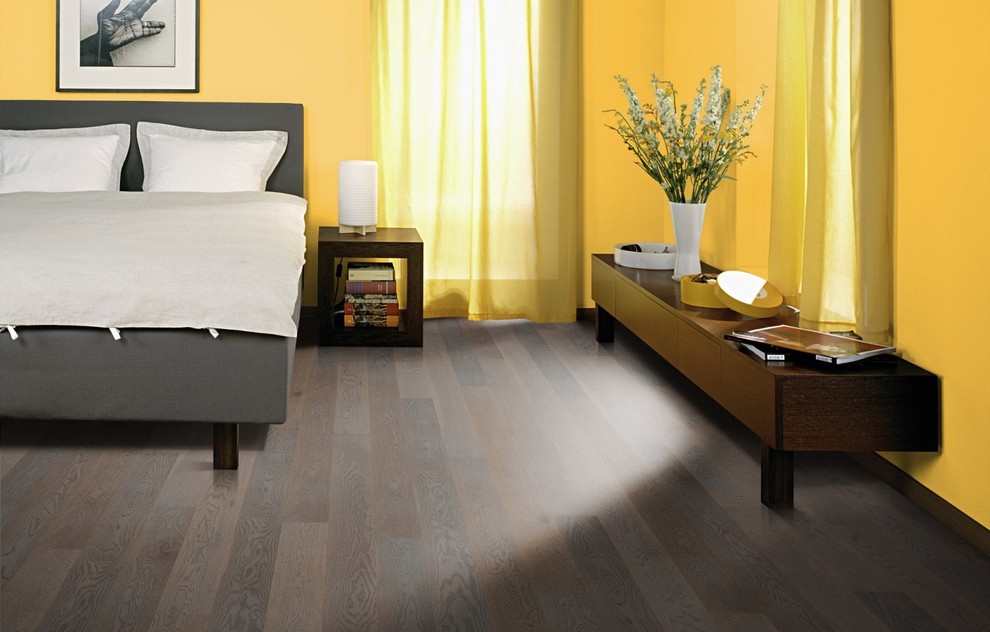 Inspiration for a traditional master bedroom in San Francisco with yellow walls and dark hardwood flooring.