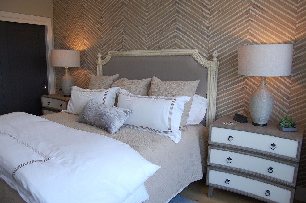 Medium sized coastal guest bedroom in Miami with beige walls, medium hardwood flooring and beige floors.