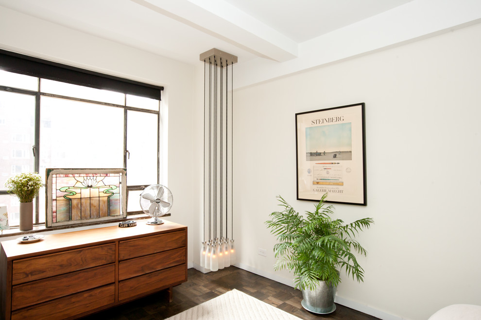 Example of an eclectic bedroom design in New York with white walls