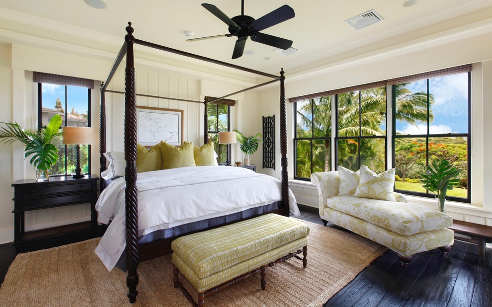 This is an example of a world-inspired bedroom in Hawaii with beige walls, dark hardwood flooring and black floors.