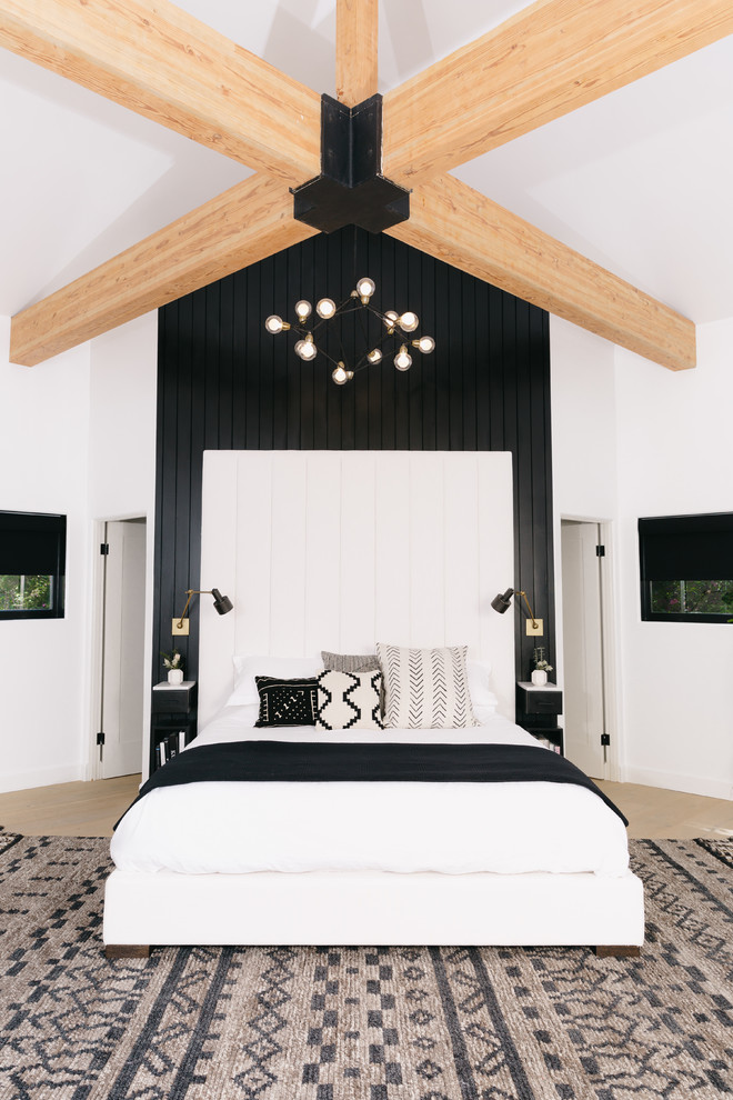 Inspiration for a cottage light wood floor and beige floor bedroom remodel in Denver with white walls