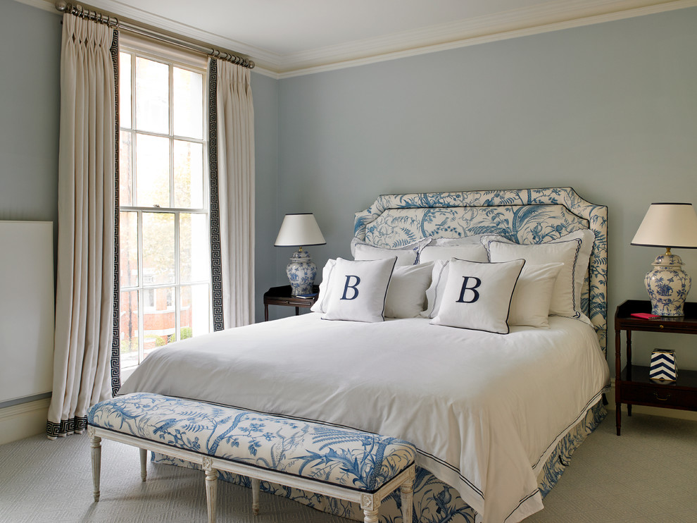 Inspiration for a traditional bedroom in London with blue walls and carpet.