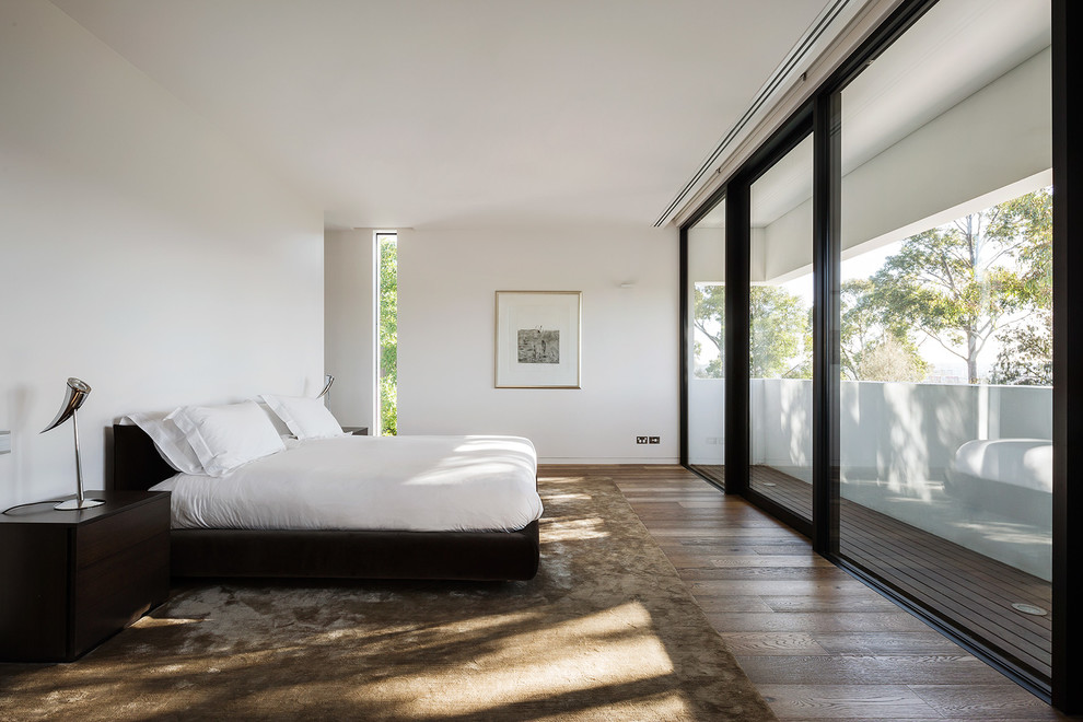 Bedroom - large contemporary master medium tone wood floor bedroom idea in Melbourne with white walls and no fireplace