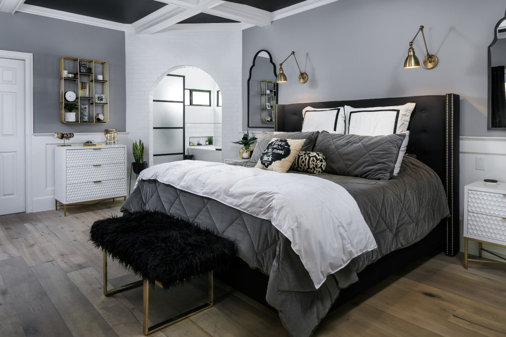На фото: большая хозяйская спальня в стиле лофт с серыми стенами, паркетным полом среднего тона, коричневым полом, балками на потолке и обоями на стенах без камина