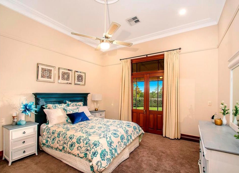 Photo of a large classic guest bedroom in Sydney with beige walls and carpet.