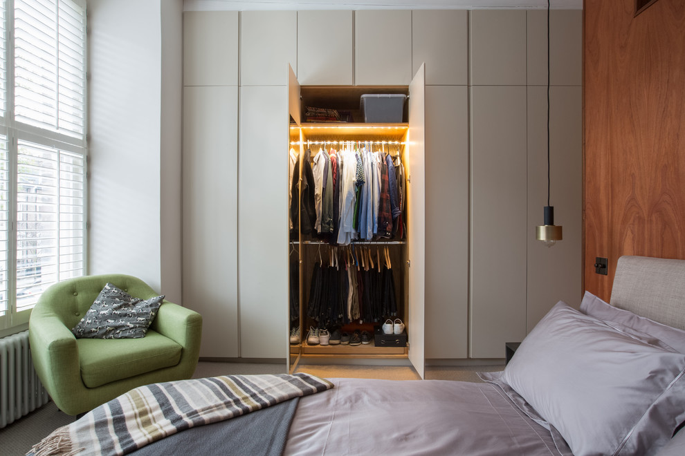 Contemporary grey and brown bedroom in London with brown walls, carpet and beige floors.
