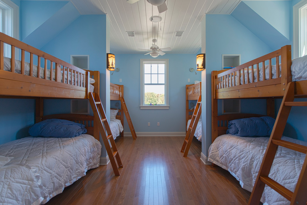 Photo of a large rural bedroom in Chicago with blue walls and light hardwood flooring.