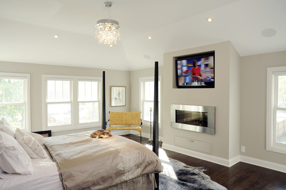 Diseño de habitación de invitados actual de tamaño medio sin chimenea con paredes grises y suelo de madera en tonos medios