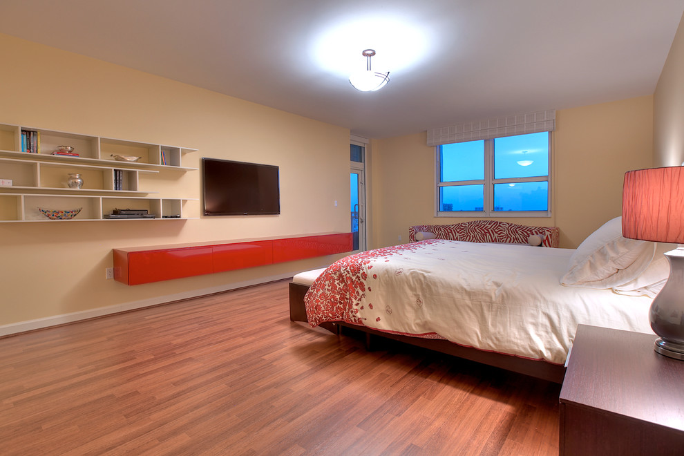 Example of a mid-sized minimalist master medium tone wood floor bedroom design in Miami with yellow walls and no fireplace
