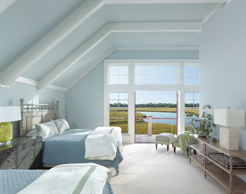 Large beach style master bedroom in Charleston with blue walls and carpet.