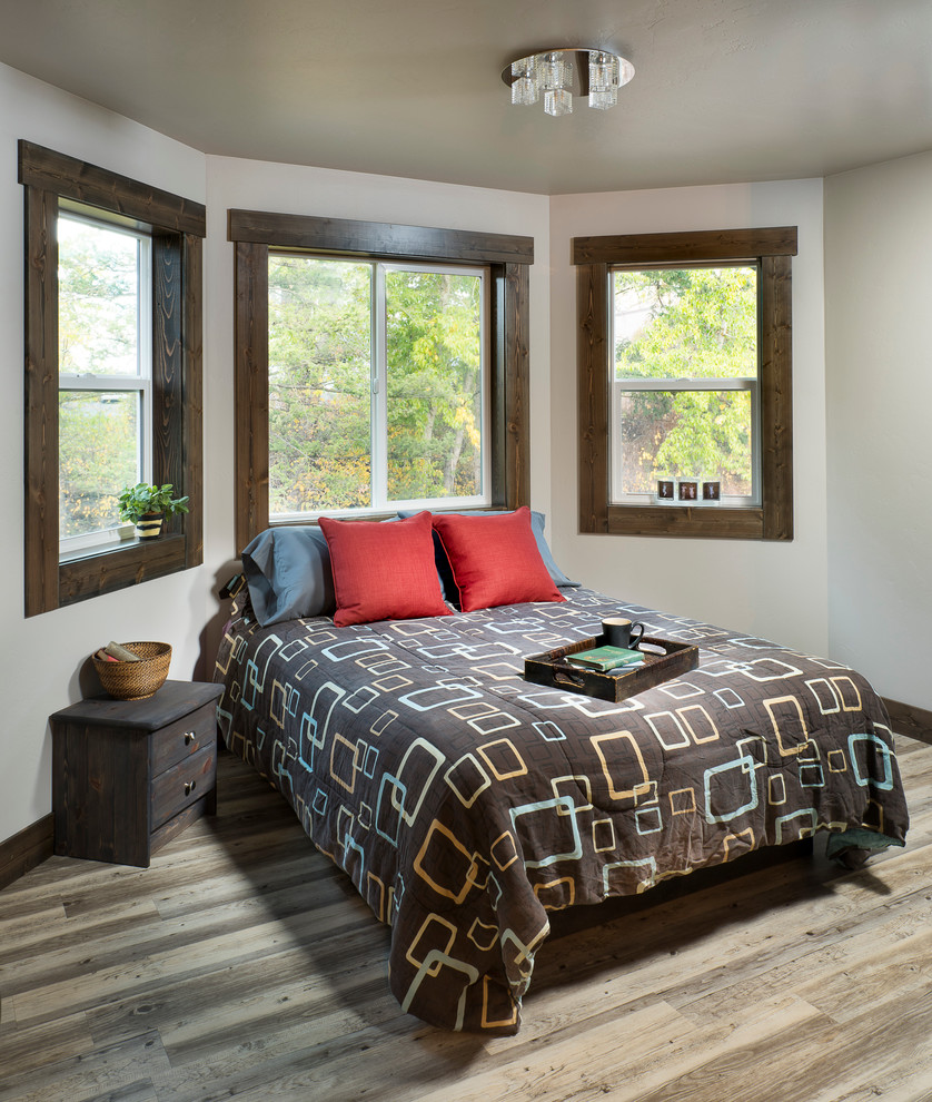 Example of a mid-sized classic guest vinyl floor bedroom design in Other with gray walls
