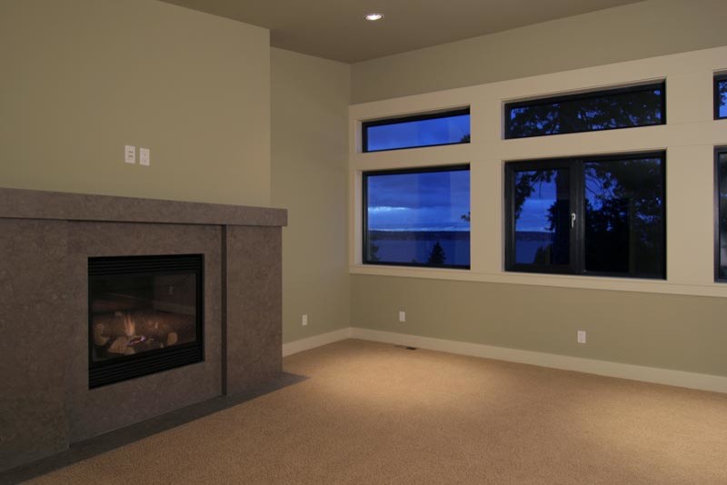 Photo of a medium sized contemporary master bedroom in Seattle with beige walls, carpet, a standard fireplace and a stone fireplace surround.