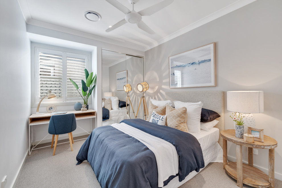 Design ideas for a beach style guest bedroom in Brisbane with grey walls, carpet and beige floors.